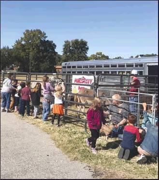 PONCA CITY HIGH School FFA students brought animals for a petting zoo to Liberty Elementary School to help celebrate their 1st Quarter celebration. Photo shows first grade students from Christie Brown and Morgan Weatherly’s classes.