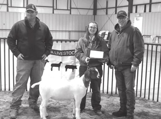 Grand Champion Wether Goat, Kristyn Flanery with show judge Justin Stacy and sponsor Atwood’s Ranch and Home, Manger Ron Roehl.