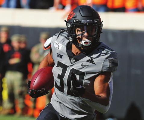 IN THIS Saturday, Nov. 16, 2019, file photo, Oklahoma State running back Chuba Hubbard (30) carries against Kansas during an NCAA college football game in Stillwater, Okla., Saturday, Nov. 16, 2019. Oklahoma State has high hopes with Heisman contender Chuba Hubbard and star receiver Tylan Wallace. (AP Photo/Sue Ogrocki)
