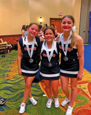 All-American Junior High Cheerleaders, from left, Gwyneth Goddard, Katrina Kiser and Kaitlyn Hall.