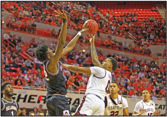 KALIB BOONE of Oklahoma State blocks Texas Tech's Kyler Edwards' shot during a game in Stillwater Saturday. The Cowboys defeated Texas Tech 73-70. (AP Photo)