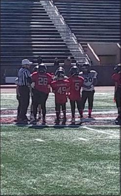 CAPTAINS FROM the Winfield Elite and Bandits meet at mid-field at Sullins Stadium for the coin toss before the game. (News Photo by Jessica Windom)