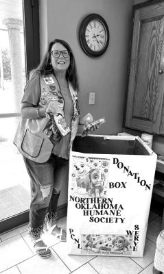 THE PONCA City Noon Lions Club will be collecting various items including used towels, blankets, dog food, and cat food as part of a campaign in partnership with the Northern Oklahoma Humane Society. Pictured is Katrina Sinor with the donations box. (Photo Provided)