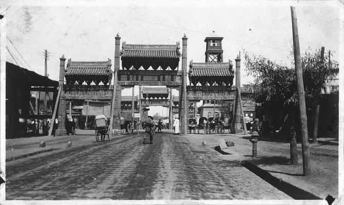 HOWARD C. Goodrich (American, 1902-1925), Untitled (Street Scene with Guardian Lion, Peking), 1925, gelatin silver print. Private Collection.