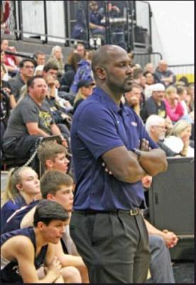 PONCA CITY head boys coach Ivan McFarlin watches hie team compete against Sand Springs in the opening game of the season last week. The Wildcat boys will play in a tournament in Cleveland beginning Thursday, while the girls will play in a tourney in Bixby, also getting underway on Thursday. (News Photo by David Miller)