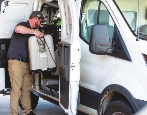 GEOFF WALKER of CareSource loads oxygen machines into his van at Grace Skilled Nursing and Therapy in Norman on March 26. (Whitney Bryen/Oklahoma Watch)