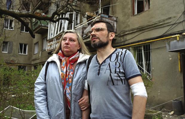 LOCAL RESIDENTS watch as rescuers work at the site of a missile strike in the center of Kharkiv, on April 7, 2024, amid the Russian invasion in Ukraine. (Sergey Bobok/AFP via Getty Images/TNS)