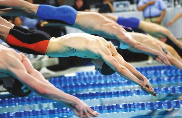 IN THIS JAN. 17, 2016, file photo, Andrew Wilson, center, competes in the men’s 100-meter breaststroke during the Arena Pro Swim Series in Austin, Texas. USA Swimming has announced its plans for a return to competition, beginning with a series of regional events in August before the national schedule begins in early November at Richmond, Virginia. (AP Photo, File)