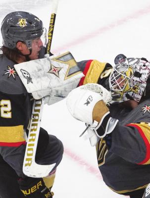 VEGAS GOLDEN Knights goalie Robin Lehner (90) makes a save as Zach Whitecloud (2) defends during the third period against the Chicago Blackhawks in Game 1 of an NHL hockey Stanley Cup first-round playoff series, Tuesday, Aug. 11, 2020, in Edmonton, Alberta. (Jason Franson/The Canadian Press via AP)