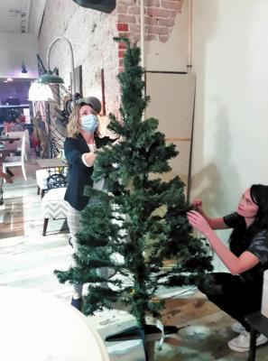 Soroptimist Angel Tree Project Co-chairs Tracy Ogden, left and Heather Sumner, right, set up the Soroptimist Angel Tree in PC Provisions.