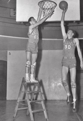 BOB KURLAND, right, of Oklahoma A&amp;M, demonstrates his length as compared to a teammate. Kurland, who 7 feet tall was the Most Valuable Player in both the 1945 and 1946 NCAA Tournaments won by Coach Henry Iba’s Oklahoma A&amp;M team.