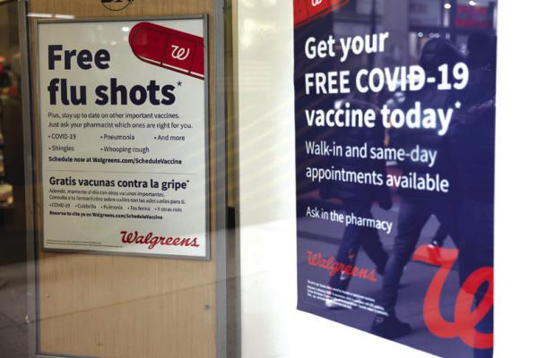 In this file photo, flu and coronavirus (COVID-19) vaccine signage is seen at a Duane Reade by on Broadway on January 05, 2023 in New York City. (Michael M. Santiago/Getty Images/TNS)