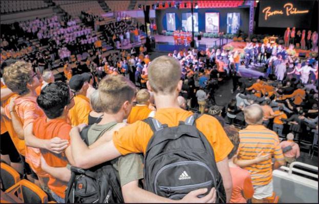 FANS AND STUDENTS sing the OSU Alma Mater at the end of the Celebration of Life event for T. Boone Pickens, Wednesday, Sept. 25, 2019 at Gallagher-Iba Arena in Stillwater. (Photo by Gary Lawson, OSU Brand Management)