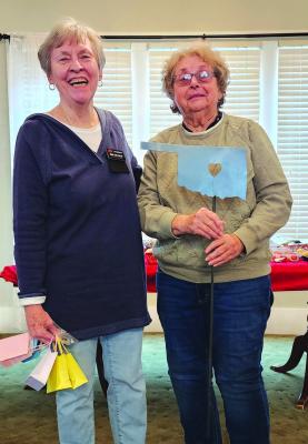 Mary Lynn Taylor, recognition chair presents Linda Williamson, with her lifetime gardener yard stake. (Photo: Kay County OSU Extension)
