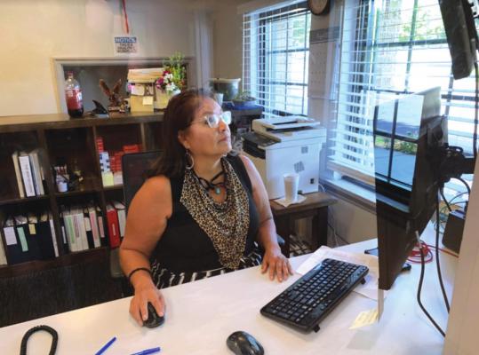 Kim Holmes at work in her office at the Altamont Apartment complex in Tulsa where she works as a property manager for the Mental Health Association of Oklahoma. Gaylord News photo / John Gott