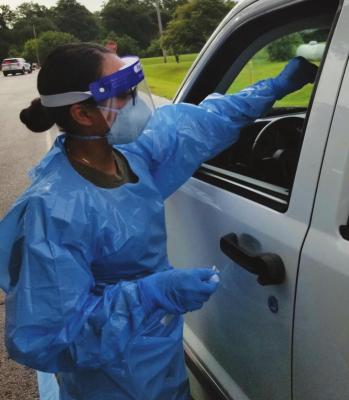 A health worker screens for COVID-19 during a drive thru testing event at the Otoe-Missouria Tribal Complex in Red Rock earlier this month. The Otoe-Missouria Tribe has hosted several events at the complex to help those who live in rural Oklahoma have access to testing. The tribe was recently awarded a grant to help the tribe establish a COVID-19 Response Center at the tribal complex.