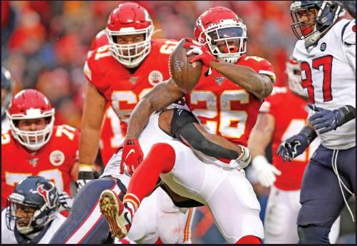 KANSAS CITY Chiefs running back Damien Williams (26) scores a touchdown past Houston Texans safety Justin Reid (20) during an NFL divisional playoff game in Kansas City, Mo., Sunday. The Chiefs won 51-31 after trailing 24-0. (AP Photo)