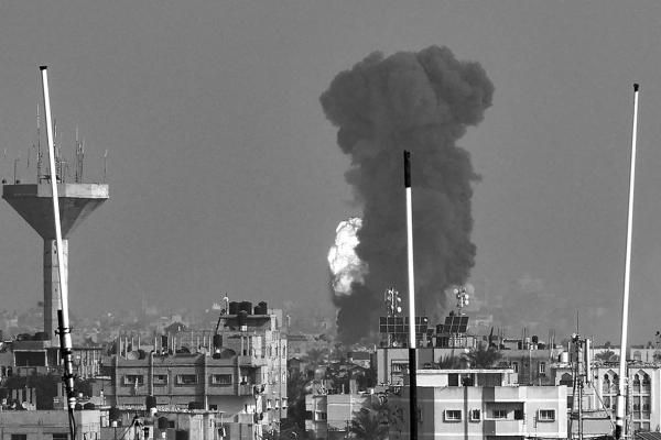 SMOKE RISES above buildings during an Israeli strike on Rafah in the southern Gaza Strip on Dec. 1, 2023, after battles resumed between Israel and the Hamas movement. (Said Khatib/AFP/Getty Images/TNS)