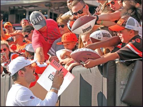 CLEVELAND BROWNS quarterback Baker Mayfield, left, gives autographs after the Orange and Brown Scrimmage in August in Cleveland. Mayfield isn’t concerned about the huge expectations being placed on the Browns, who went 7-8-1 during his rookie season but upgraded their roster and should compete for their first playoff spot since 2002. (AP Photo)