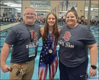PONCA CITY swimmer Mattie Shearer won the state championship in the 100 Breaststroke Friday at the OSSAA State Swim Meet in Edmond. Shearer is flanked above by Ponca City Assistant Coach Derek Taylor, left; and Head Coach Heather Harris.
