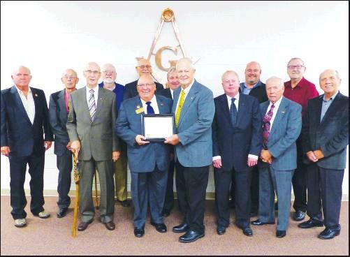 PAST GRAND Masters of Ponca Lodge #83 gather to receive a certificate celebrating 125 years of service to community and brotherhood in Ponca City. Presenting the certificate to Larry Logan is Worthy Grand Master Mike Dixson (Courtesy Photo)