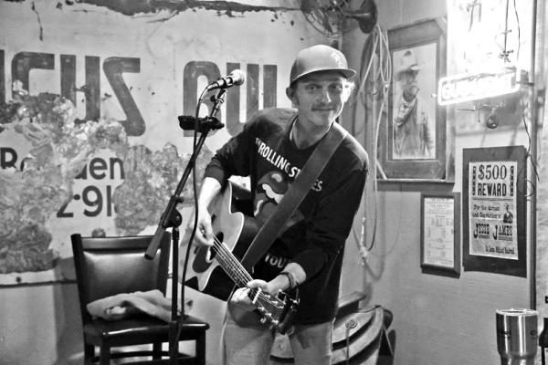 CUTLINE: UP-AND-COMING local singer/songwriter Cole Tolle performed at Arthur’s Bar and Grill on Friday, Feb. 9. He had the crowd enthralled as he sang in the hometown bar and those in attendance walked away excited for his next show. (Photo by Dailyn Emery)