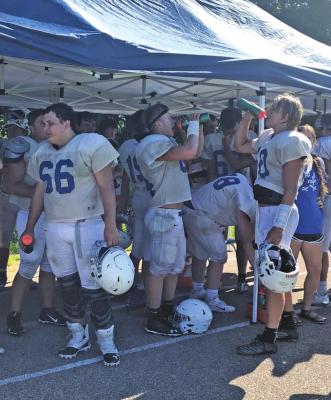 MEMBERS OF the Woodland Cougars football team take a water break during a recent practice. The Cougars, like most teams this time of year, have their sights set on a playoff spot. (News Photo by David Miller)