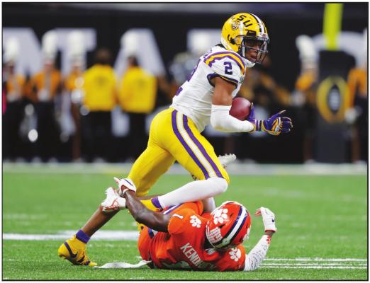 LSU WIDE receiver Justin Jefferson runs over Clemson cornerback Derion Kendrick during the first half of a NCAA College Football Playoff national championship game Monday, Jan. 13, 2020, in New Orleans. (AP Photo)