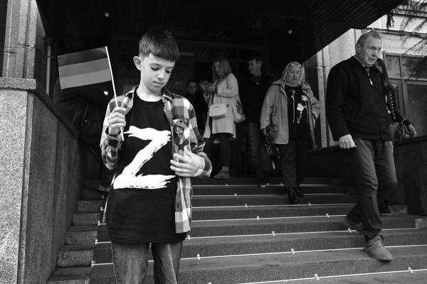A boy wearing a T-shirt with the letter ‘Z’, the tactical insignia of Russian troops in Ukraine, and holding a flag of the self-proclaimed Donetsk People’s Republic (DNR) - the eastern Ukrainian breakaway region - stands at the entrance to the DNR embassy in Moscow on September 23, 2022, as Moscow-held regions of Ukraine vote in annexation referendums that Kyiv and its allies say are illegal.