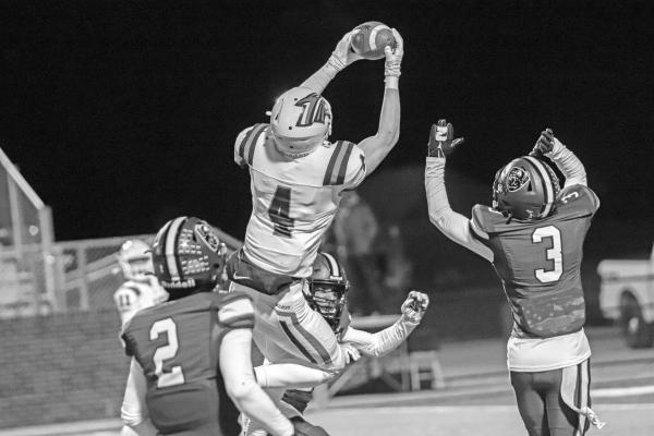 PONCA CITY'S Gavin Cunningham (4) goes high to pull down a pass during Friday's Class 6AII quarterfinal playoff game against Muskogee in Muskogee. The Muskogee Roughers defeated Ponca City 18-0 to end the season for the Wildcats. This photo provided by Justin Boyer.