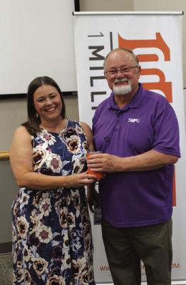 1 MILLION Cups held their regular monthly meeting on Wednesday, June 7 at 8:30 am at Pioneer Technology Center (PTC). Brook Lindsay (left) presented an orange cup to speaker Dean Meador (right) of DMP Media. The orange cup is presented to every speaker at 1 Million Cups. (Photo by Calley Lamar)