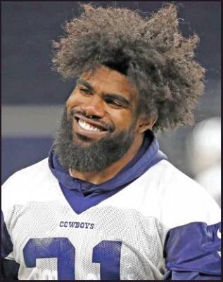 DALLAS COWBOYS running back Ezekiel Elliott smiles as he walks off the field after participating in drills during June at the team’s NFL football training facility in Frisco, Texas. The Cowboys and Elliott have agreed on a $90 million, six-year contract extension that will make him the NFL’s highest-paid running back and end a holdout that lasted the entire preseason, a person with knowledge of the agreement said Wednesday. (AP Photo)