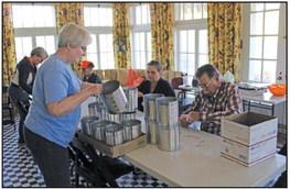 Several volunteers came together to assemble 330 old time lunch buckets for third graders that will be visiting the Marland Grand Home. (Photo by Calley Lamar)
