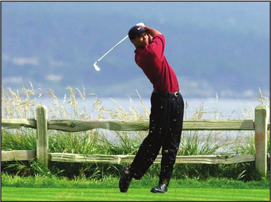 IN THIS JUNE 18, 2000, file photo, Tiger Woods tees off on the 18th hole on his way to winning the 100th U.S. Open Golf Championship at the Pebble Beach Golf Links in Pebble Beach, Calif. Golf Channel is airing a one-hour special on May 24 of Woods winning all four majors in a span of 10 months. (AP Photo/Elise Amendola, File)
