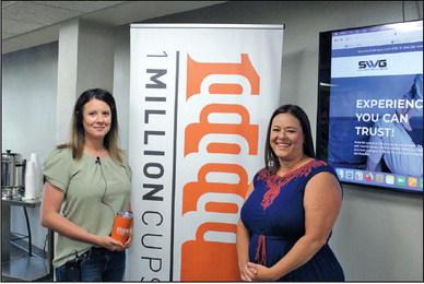 JESSICA FIELDS (left) was the speaker at 1 Million Cups on Wednesday, Sept. 6 representing Stolhand-Wells Group (SWG), she is pictured with Brooks Lindsay, who presented her with an orange cup that is given to speakers at 1 Million Cups. (Photo by Calley Lamar)
