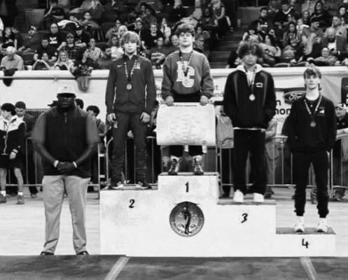 PONCA CITY wrestler Christopher Kiser stands on the winners’ stand after securing his second consecutive individual state championship