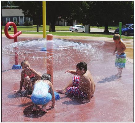 SEVERAL CHILDREN were recently playing at the Splash Pad on 7th St. Their grandma told me they just moved to Ponca City from Edmond and they were enjoying the hot weather as fall is rapidly approaching us. (News Photo by Jessica Windom)
