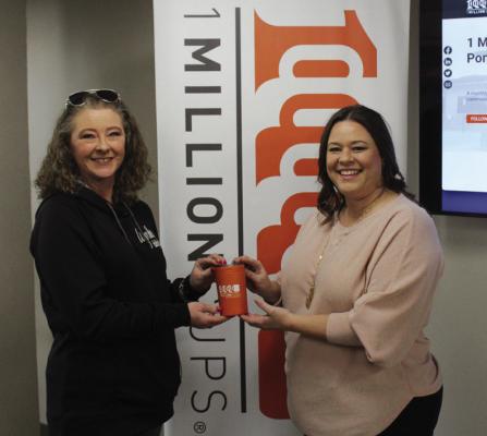 SHAWNDRA SHEIK (left), owner of Waymakers Floral, was the speaker for the 1 Million Cups event held at Pioneer Technology Center on Wednesday, Feb. 7. Sheik was presented with an orange cup, which is given to all speakers. Sheik is pictured with Brook Lindsay (right). (Photo by Calley Lamar)