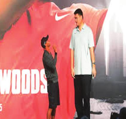 YAO MING, because of his imposing 7-foot-6 height, has been a favorite commercial subject. Here his height is on display standing near golfer Tiger Woods.