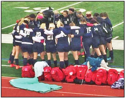MEMBERS OF the Ponca City Lady Cats varsity soccer team pray before beginning play at the Stillwater Festival Tuesday in Stillwater. The Ponca City team played Stillwater twice and won both matches 2-0. The official soccer season gets underway March 6 when Guthrie visits Po-Hi’s Sullins Stadium. This photo provided by Laura Windom.