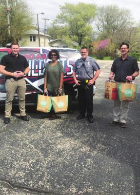 MEMBERS OF the Ponca City Police Department and two police chaplains show the Blessing Bags that were put together by volunteers from Albright United Methodist Church. In the photo are, from left, Ptl. Caleb Peterson, chaplain Rev. Tracey Ivy, Cpl. Eric Welch and chaplain Rev. Gary Wilburn.