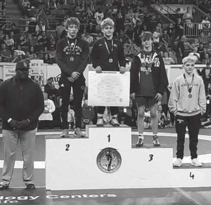 CHRISTOPHER KISER (center) is on the medal stand after winning the 106-pound championship at the OSSAA Class 6A State Wrestling Tournament Saturday. Ponca City Coach Justin Roland is at left.
