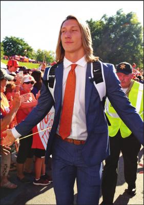 IN THIS AUG. 29, 2019, file photo, Clemson’s Trevor Lawrence greets fans as he arrives for the team’s NCAA college football game against Georgia Tech in Clemson, S.C. Lawrence and girlfriend Marissa Mowry have restarted their efforts to raise funds for those affected from the coronavirus in his Georgia hometown and the area of Upstate South Carolina where their colleges are located. (AP Photo/Richard Shiro, File)