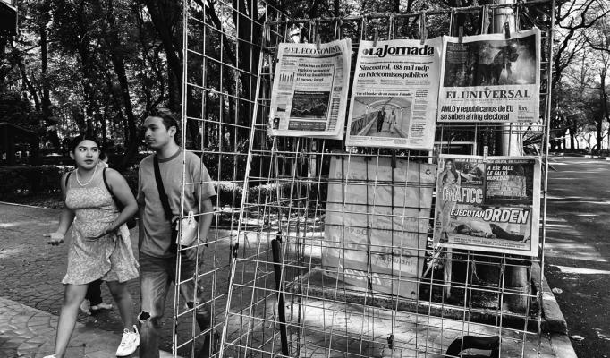 Bystanders walk by a newspaper rack in Mexico City’s Parque Mexico. Many of the headlines are dominated by talk of threats of U.S. military intervention to take on cartels and fentanyl labs. (Alfredo Corchado/The Dallas Morning News/TNS)