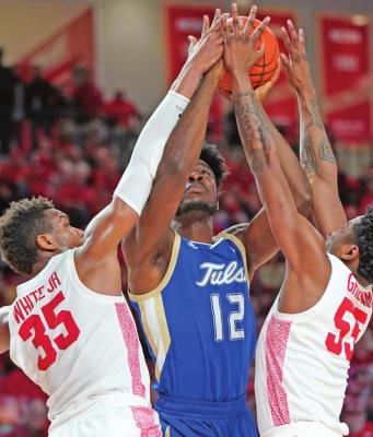 EMMANUEL UGBOH of Tulsa (12) tries to shoot between Houston’s Fabian White Jr. (35) and Brison Gresham (55) during a college basketball game Wednesday in Houston. Houston bombed Tulsa 76-43. (AP Photo)