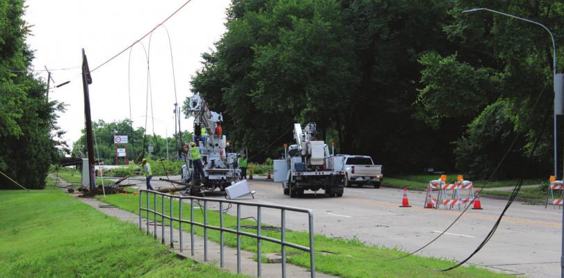 City crews worked to repair downed power lines on Lake Road in the morning on June 10. (Photo by Calley Lamar)