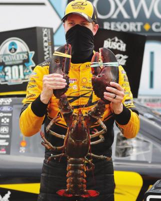 DRIVER BRAD Keselowski holds a giant lobster to celebrate his victory in a NASCAR Cup Series auto race, Sunday, Aug. 2, 2020, at the New Hampshire Motor Speedway in Loudon, N.H. (AP Photo/Charles Krupa)