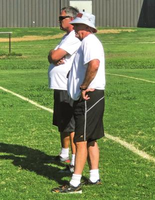 TONKAWA BUCCANEER Head Coach Mike Kirtley (right) and assistant Kurt Kirtley supervise a drill during a recent practice session in Tonkawa.