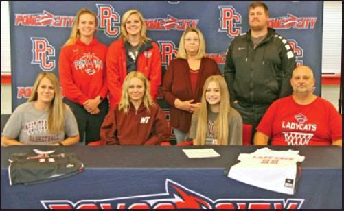 BAYLEE FINCHER of Ponca City Wednesday signed a letter of intent to play basketball at West Texas A&amp;M, Canyon, Texas. Among those at the signing were, front row from left, Amy Fincher, mother; Ashlynn Fincher, sister; Baylee Fincher; Jody Fincher, father and head coach; back row, Kayla Demel, Po-Hi assistant coach; Mica Havens, Po-Hi assistant coach; Sherry Hendrick, grandmother; and Corey Fincher, brother. Baylee will be a senior on this year’s Lady Cat basketball team. (News Photo by David Miller)