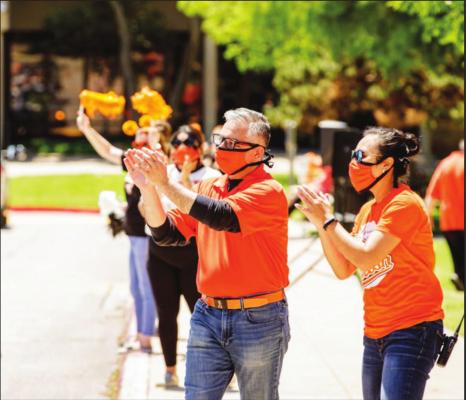 OKLAHOMA STATE University-Oklahoma City faculty and staff cheer students May 17 during a drivethrough graduation celebration that replaced the traditional ceremony that could not be held because of COVID-19. (Photo provided by OSU-OKC)